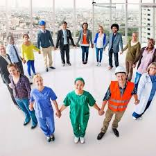 A group of people holding hands in the middle of a circle.