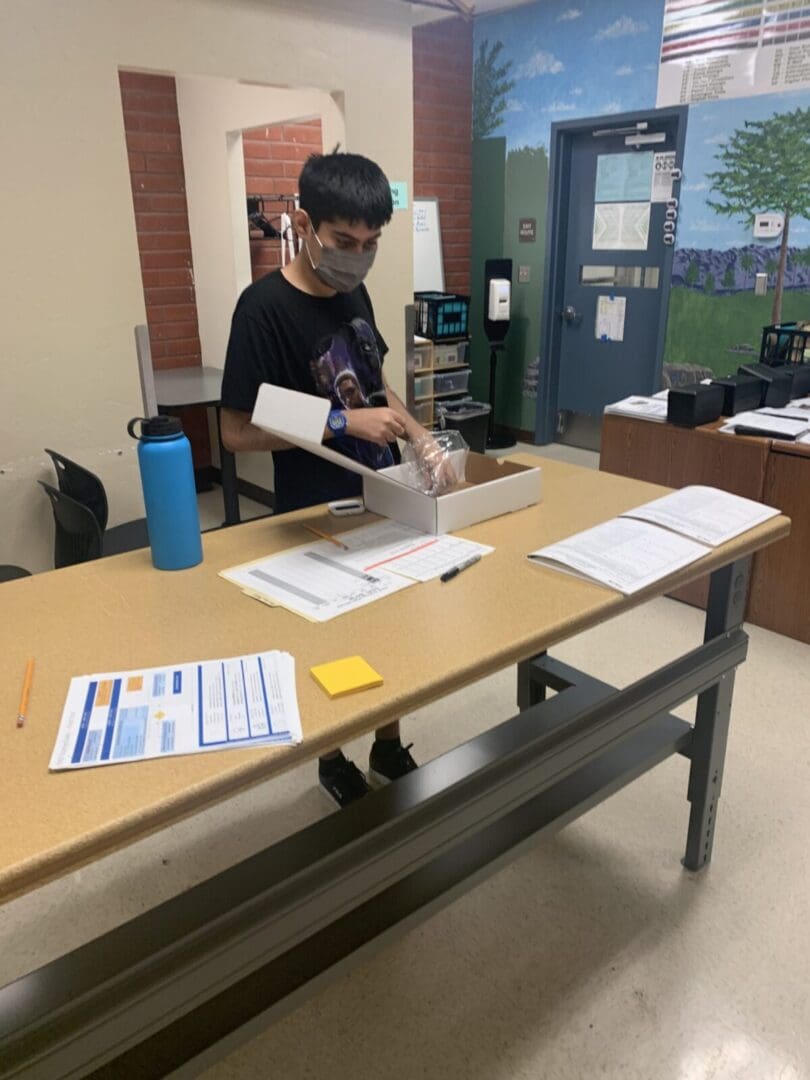 A person sitting at a table with papers on it