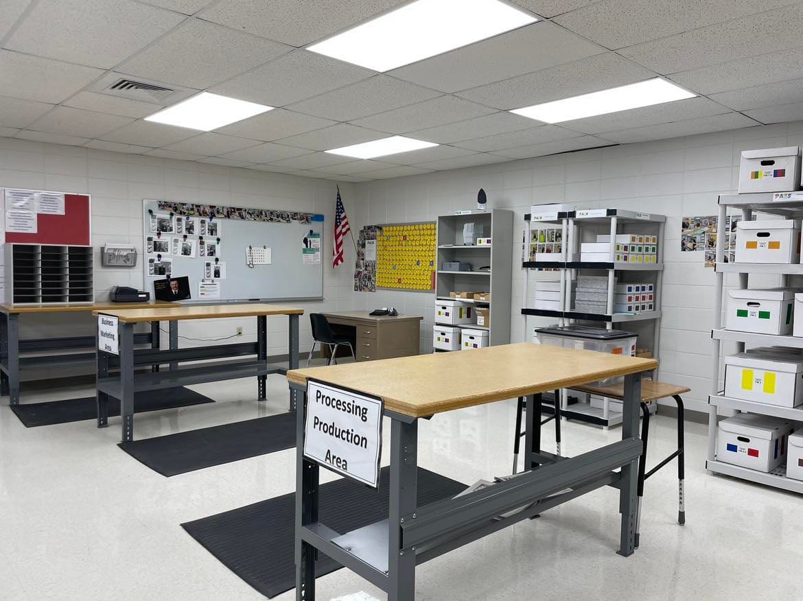 A room with several tables and shelves in it.
