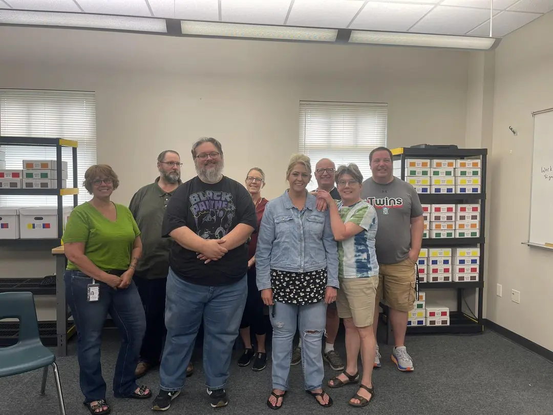 A group of people standing in front of shelves.