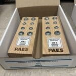 A box of two wooden boxes with the words paes on them.