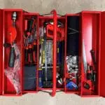 A red toolbox with many different tools inside of it.