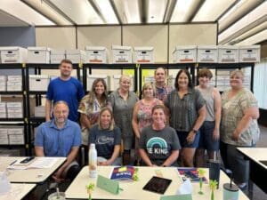 A group of people standing around a table.