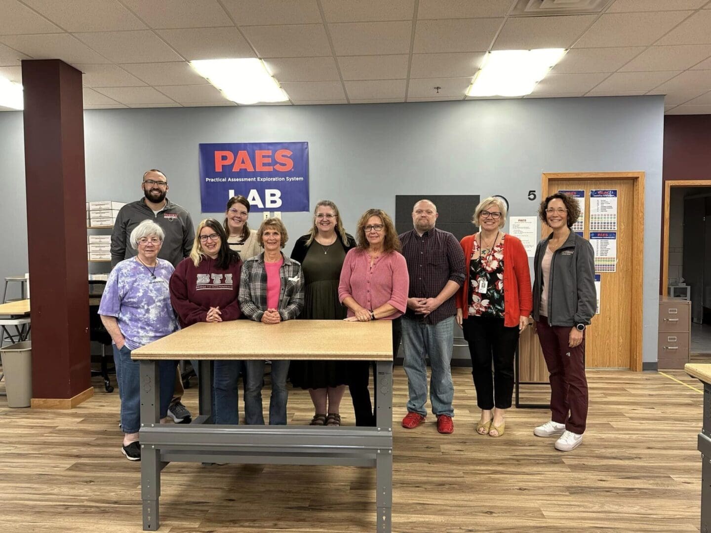 A group of people standing around a table.