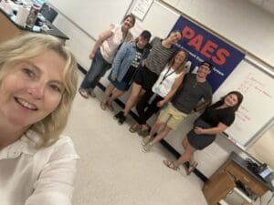Group of people smiling in a classroom.
