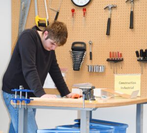 Student reading construction job instructions